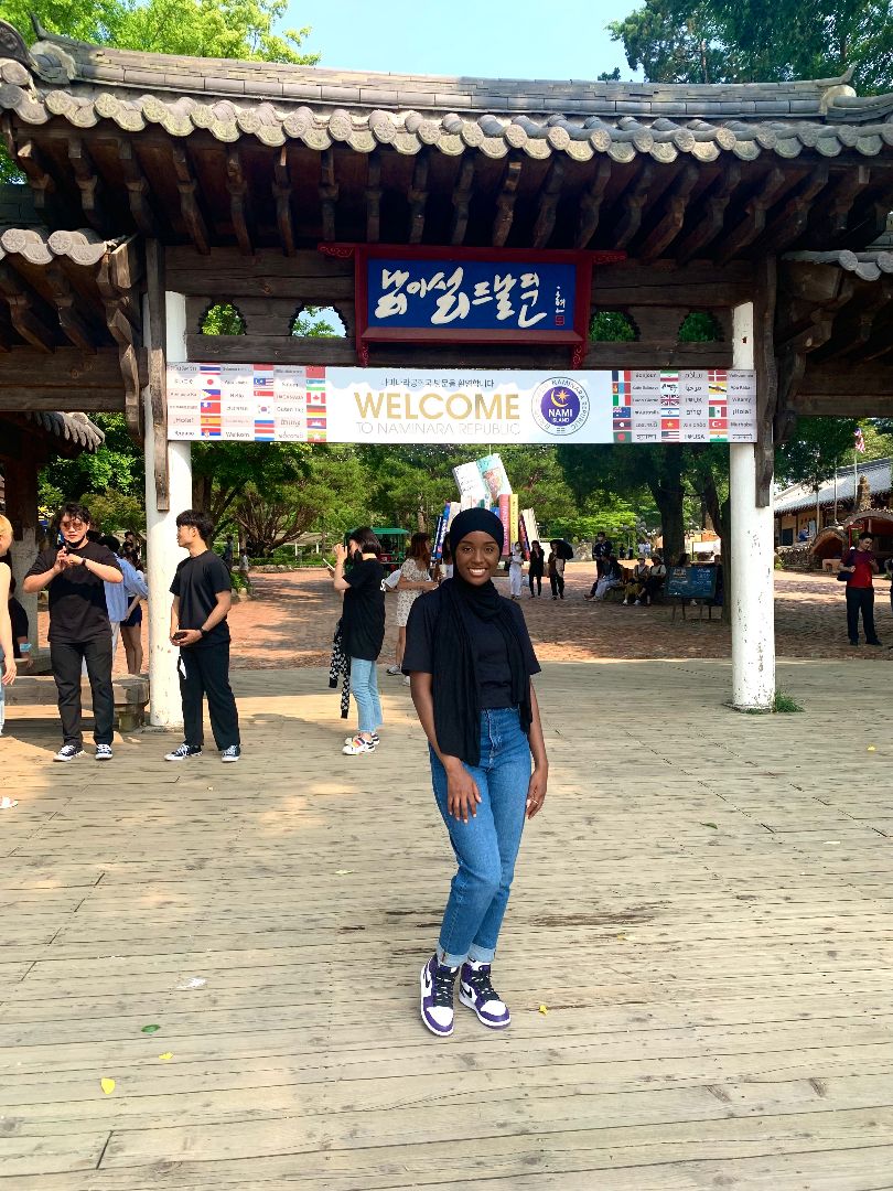 Mumina standing in front of asian structure in South Korea