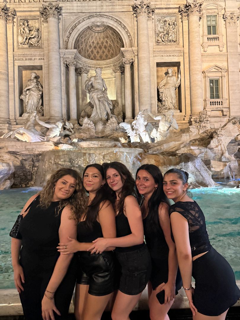 Flynn and friends posing in front of the Trevi Fountain at night