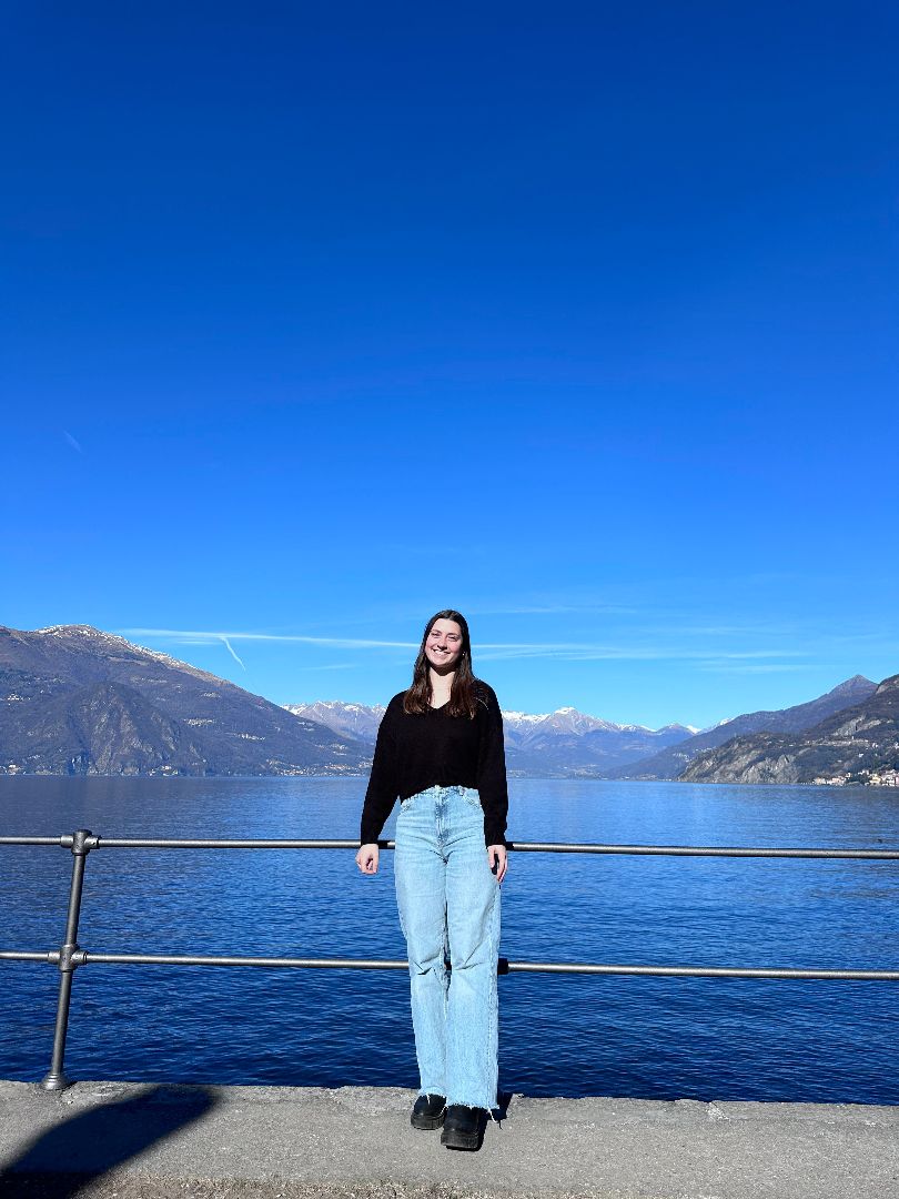 Amy standing by the sea in Italy