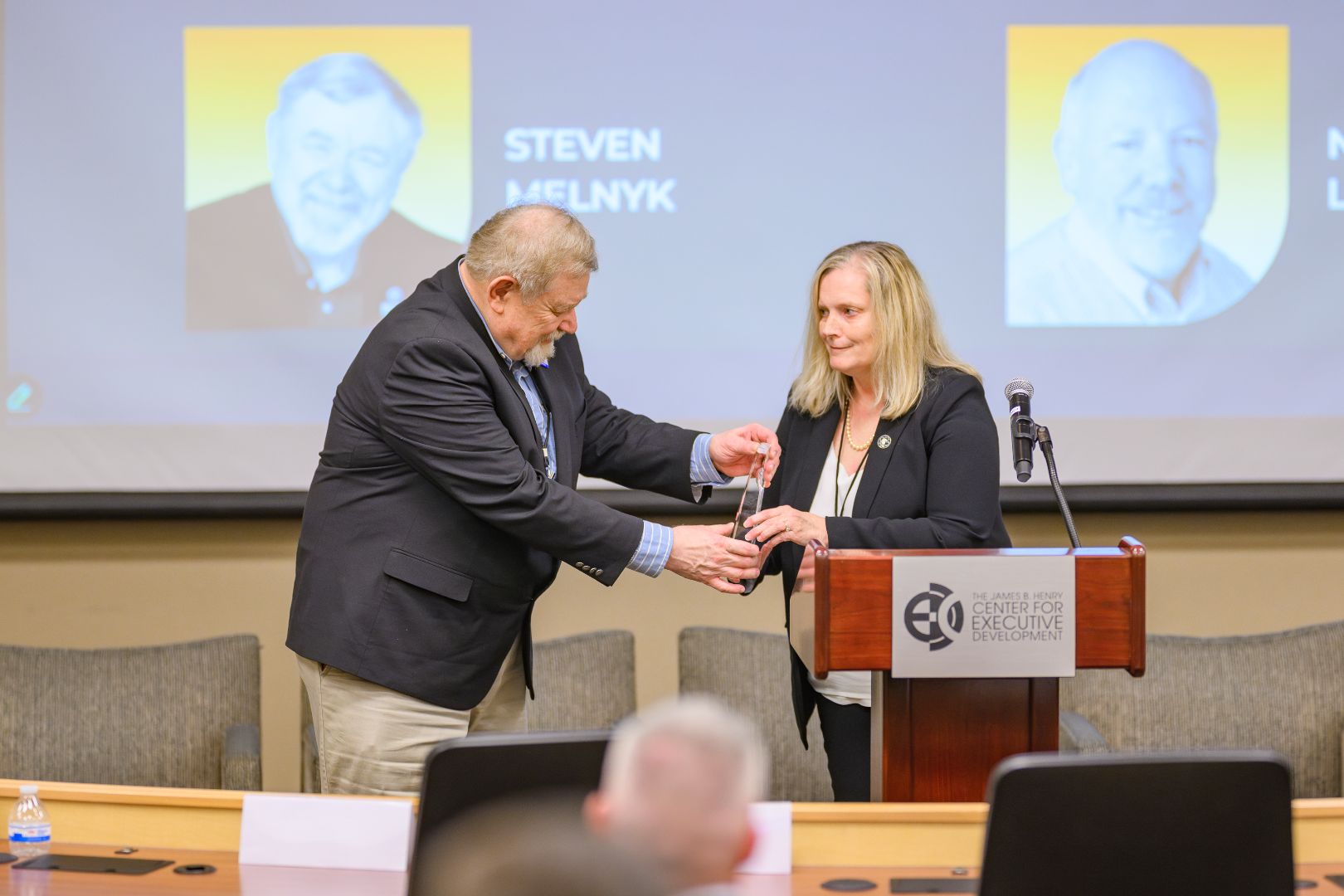 Dr. Melnyk accepting his award from Dr. Malouin