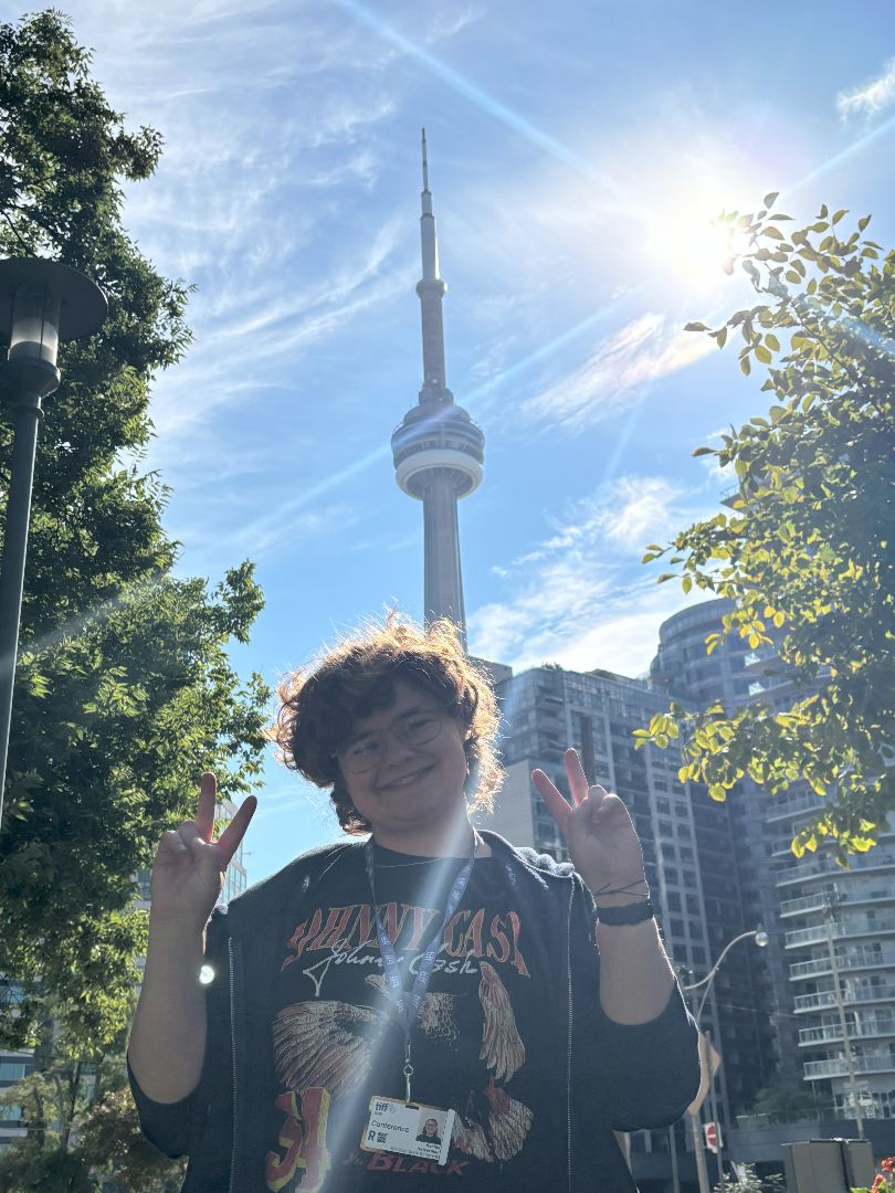Rachel giving the peace sign in front of the CN Tower