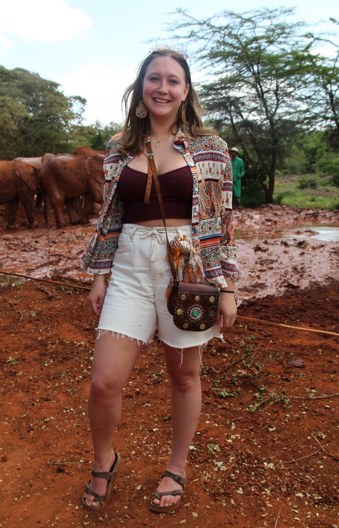 Daneille standing by elephants in Kenya