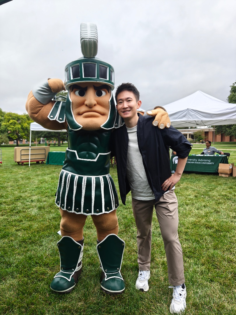 Di Wang poses with MSU mascot Sparty