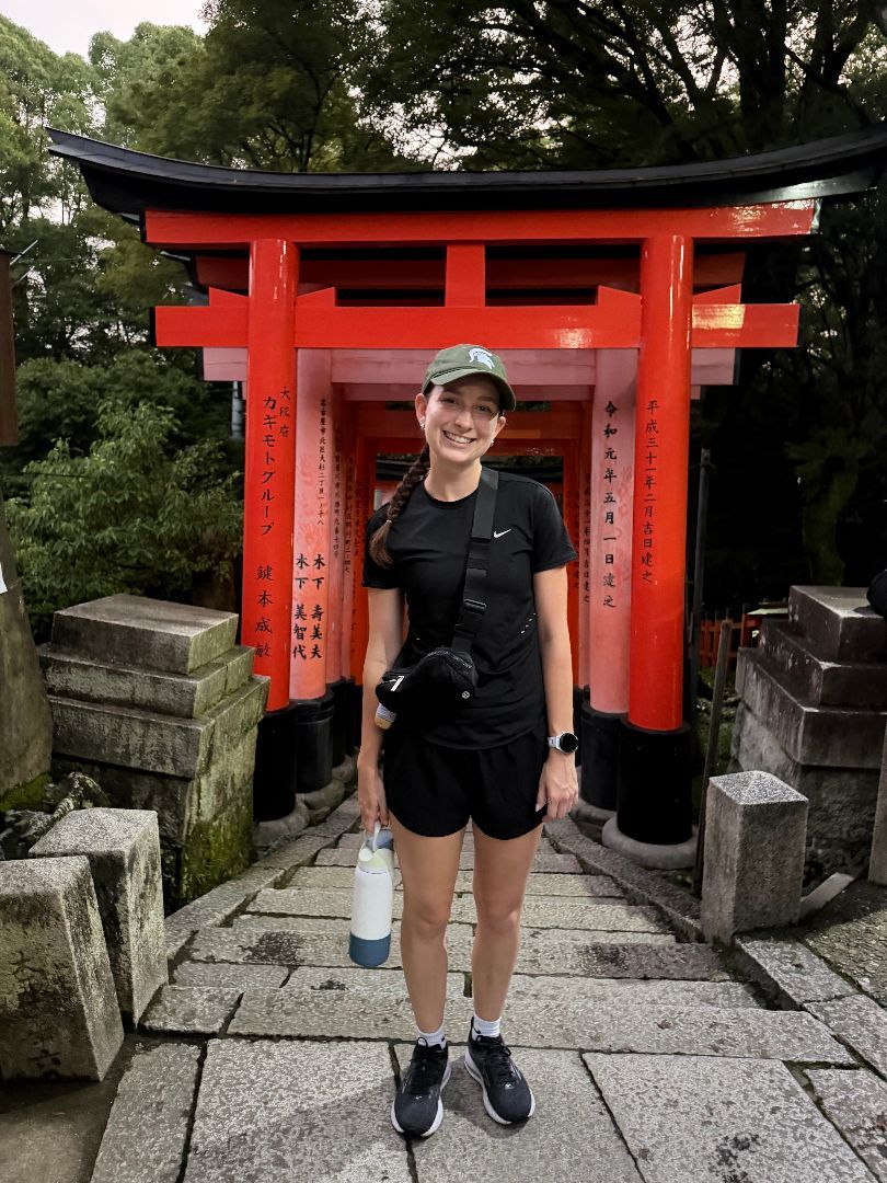 Anika standing in front of a red torri gates shrine in Japan