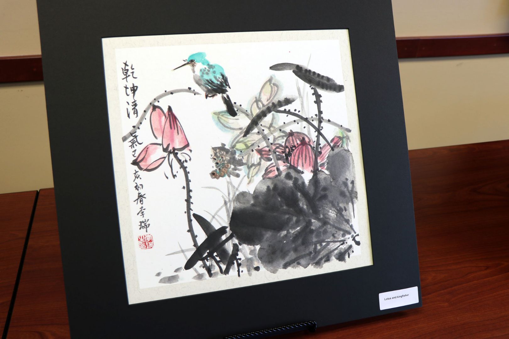 Tradition Chinese-style painting of a small bird sitting on a patch of reeds.