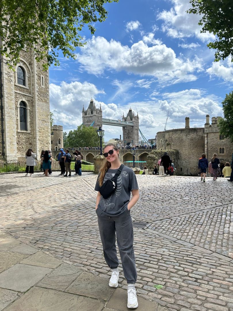 Grace posing with sunglasses at the Tower of London with Tower Bridge in the background