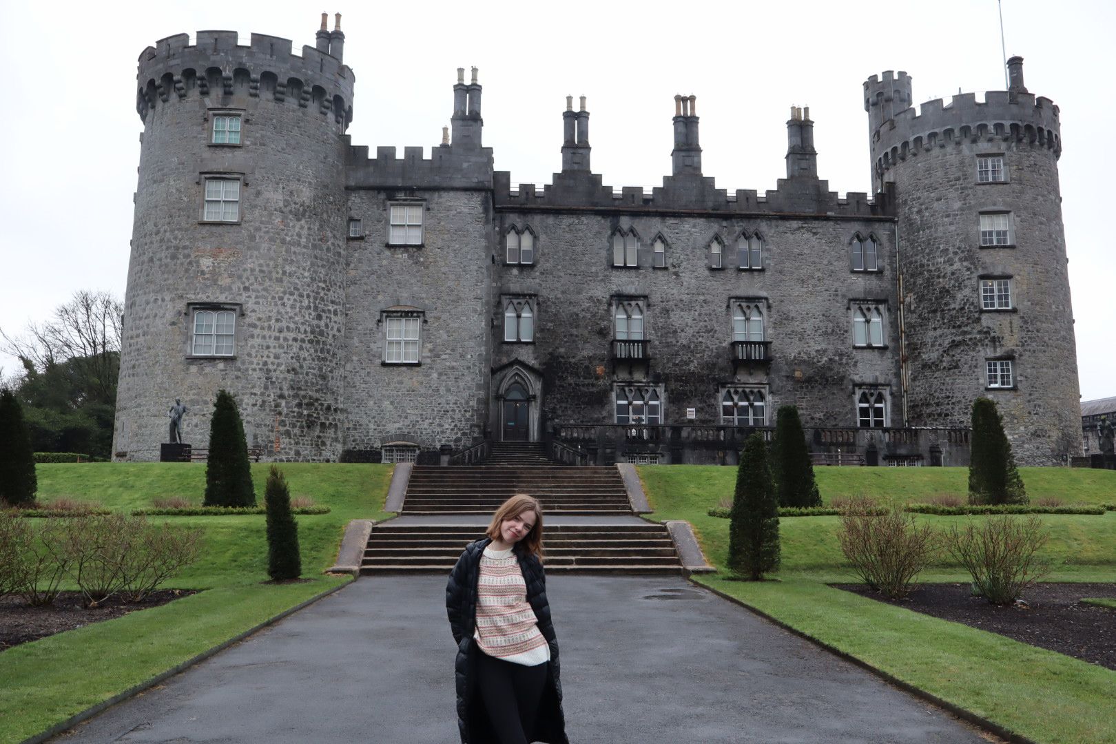 Lilly standing in front of a castle in Ireland